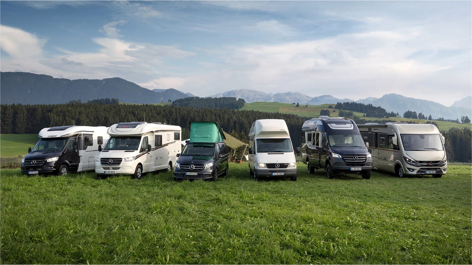 Motorhomes parked against a stunning mountain backdrop, showcasing the beauty of nature and the joy of travel.