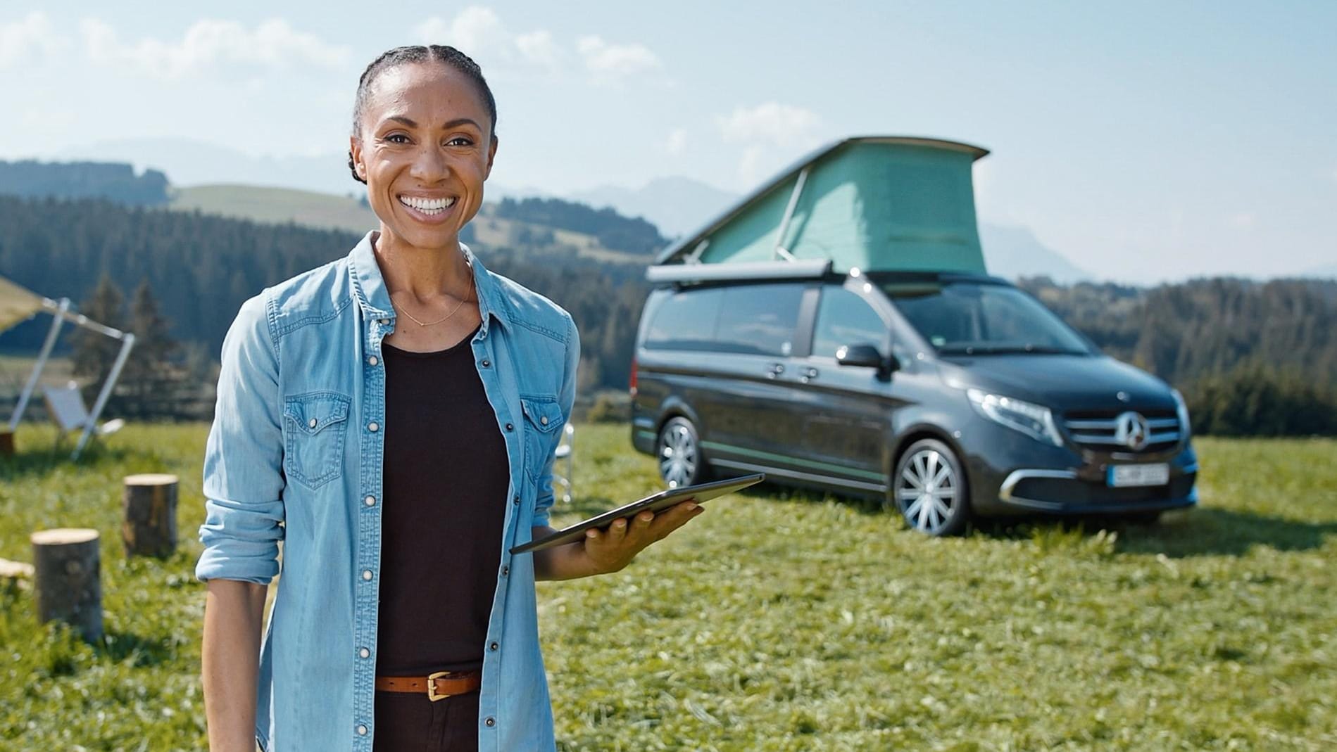 Smiling woman in front of a black van