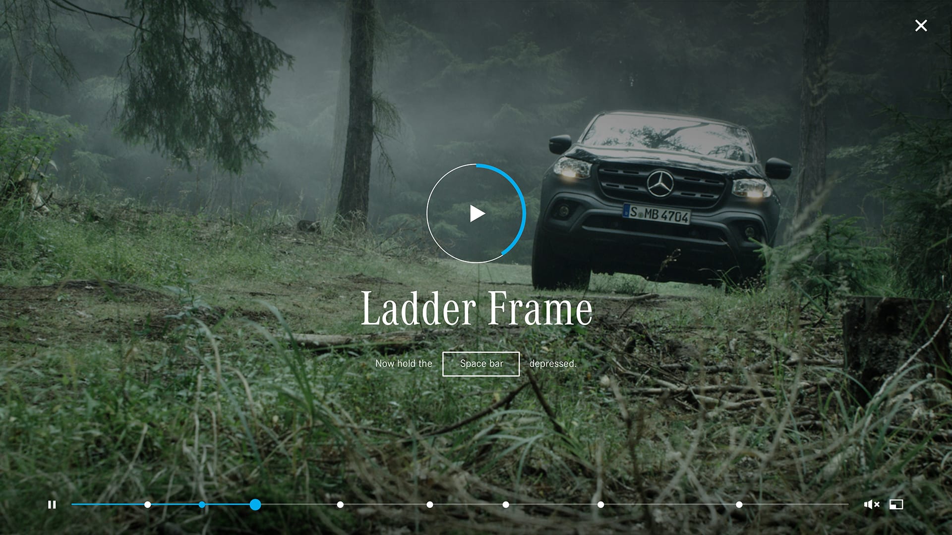 A black pickup driving through the forest